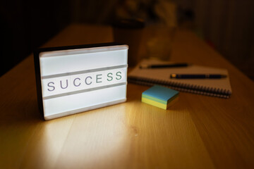 Lightbox showing success message on wooden desk