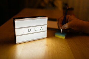 Generating idea with lightbox and hand writing notes