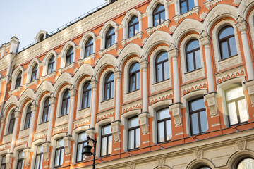 Naklejka premium Moscow building facade with ornate architectural details and arched windows