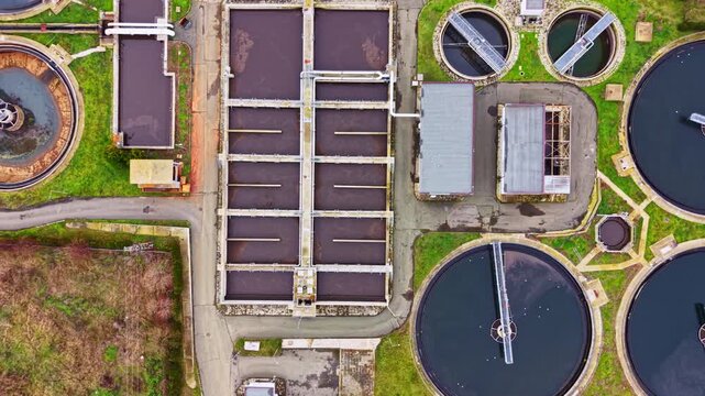 A view of a water treatment facility showing multiple round tanks and rectangular sections for processing water. This facility plays a role in ensuring clean water supply for local residents.