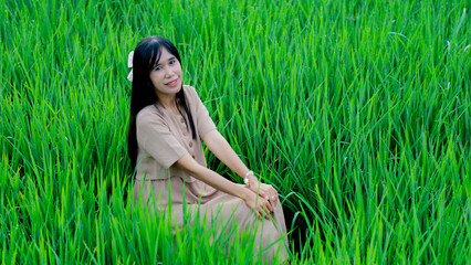 Asian woman do solo traveling to a rice field, enjoying the scenery and fresh air in the village.