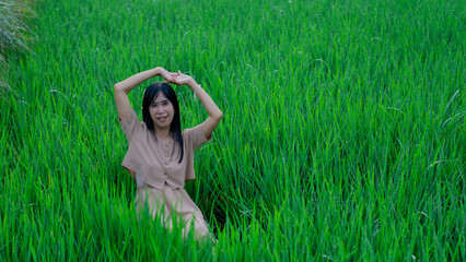 Asian woman do solo traveling to a rice field, enjoying the scenery and fresh air in the village.