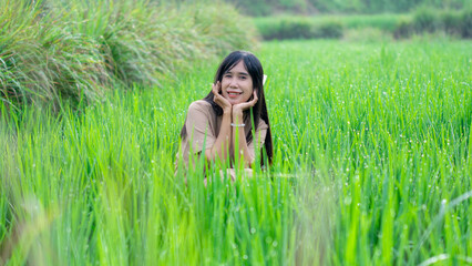 Asian woman do solo traveling to a rice field, enjoying the scenery and fresh air in the village.