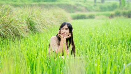 Asian woman do solo traveling to a rice field, enjoying the scenery and fresh air in the village.