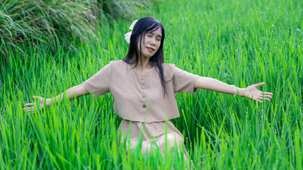 Asian woman do solo traveling to a rice field, enjoying the scenery and fresh air in the village.