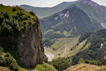 Panorama of caucasian Kazbegi mountain and architecture of ancient Georgia. drama sky, mountain peaks, high resolution photo.