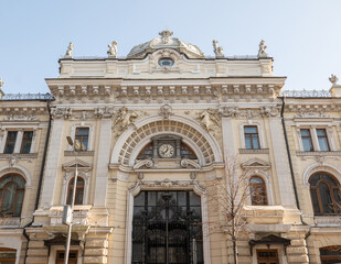 Naklejka premium Ornate historic building facade with clock and intricate architectural details in Moscow