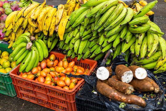 A display of fruits and vegetables at a traditional Colombian market square.