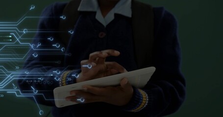 Tapping pupil holding white tablet in navy sweater white collar and backpack at school with overlay © vectorfusionart