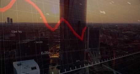 Framing dark cylindrical skyscraper at dusk from office window, showing red downward line graph