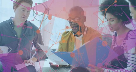 Reviewing papers, four colleagues on sofa in lounge holding blue folder, white mug, network overlay