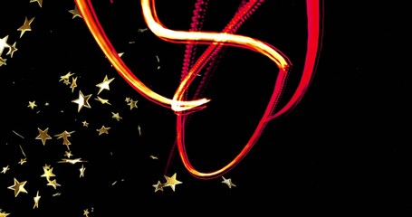 Sweeping ribbon light trails curving across black backdrop showing scattered gold star confetti