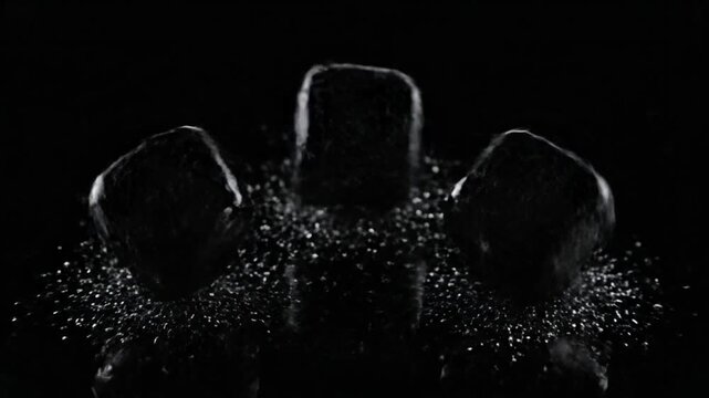 Three Ice Cubes Melting on Black Background.
