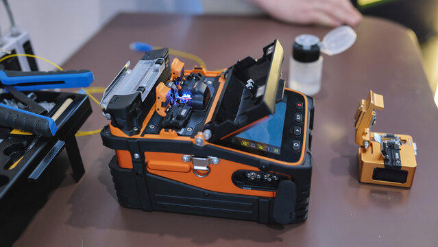 Fiber optic fusion splicer working at telecommunications technology exhibition