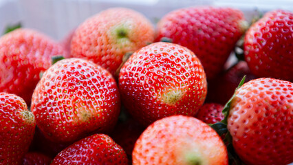 Strawberry in a white plastic box. Close-up.