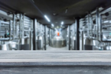 Obraz premium blurred background of modern factory and tabletop in foreground.