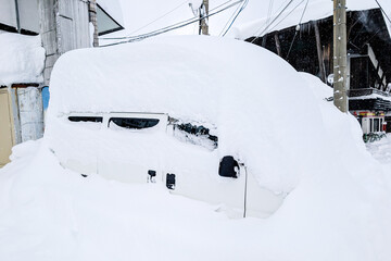 Deep powder snow burying a parked car during winter in Nagano Prefecture