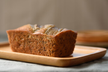 Delicious homemade banana bread or cake on rustic wooden plate