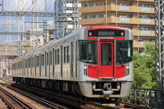 Fukuoka Japan - 2024 July 07: Nishi-Nippon Railroad (Nishitetsu) 9000 series train (car number 9501) running on the Tenjin Omuta Line. The stainless steel train