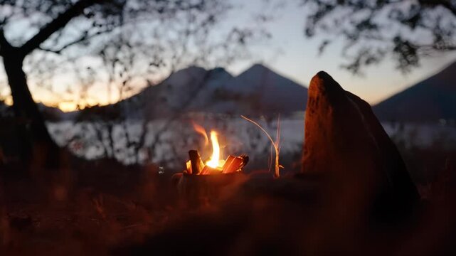 Ocote fire burns during Mayan ceremony with Lake Atitlan volcanoes