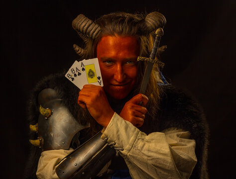 Tiefling rogue with dagger and cards
