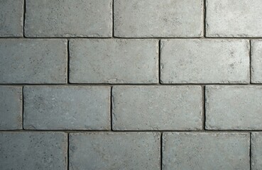 Obraz premium Close view of light grey concrete blocks laid in running bond pattern. Textured surface shows rough grainy aggregate within smooth cementitious material.