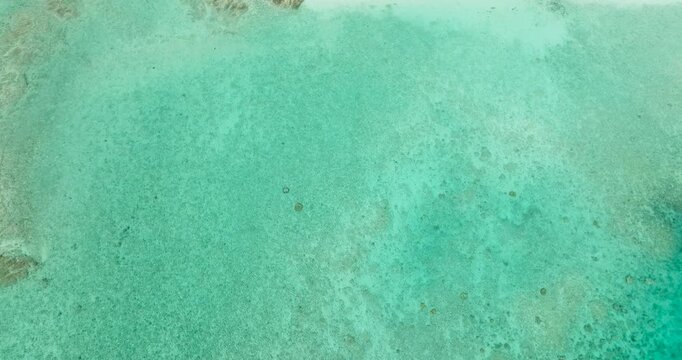 Flying over the turquoise sea water in Romblon Island with beach. Romblon, Philippines.