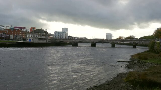 The River Shannon and Sarsfield Bridge in Limerick, Ireland during a cloudy late afternoon.