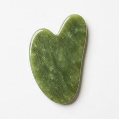 Jade gua sha heart shaped tool isolated on white background