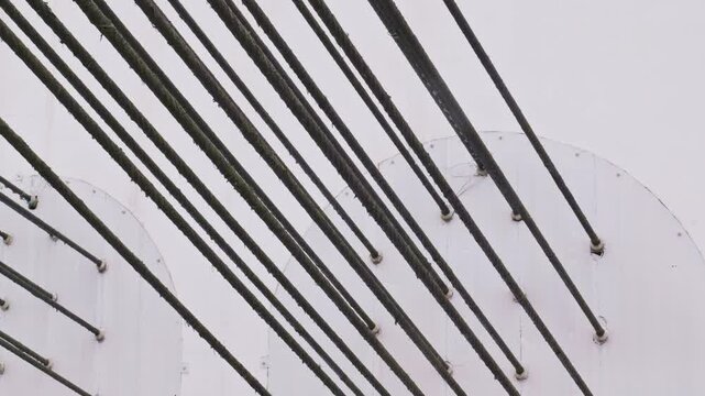 Dozens of black steel bars were embedded in the white wall.