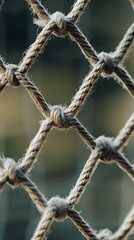 Close-up of sturdy rope mesh with intricate knots on blurred background