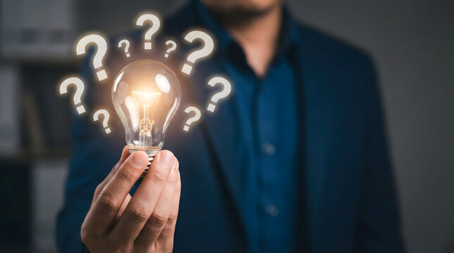Person,hand,holding,light,bulb,surrounded,by,question,marks,representing,creative,thinking,problem,solving,finding,new,business,ideas,innovative,inspiration,and,brainstorming,solutions