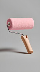 Obraz premium Painting roller with pink cover on gray background 