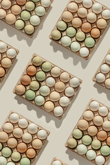 Top view pattern of natural colored easter Eggs in paper package, minimal trend Chicken egg with neutral earth pastel color, Easter food concept, natural aesthetic beauty of farm-fresh produce.