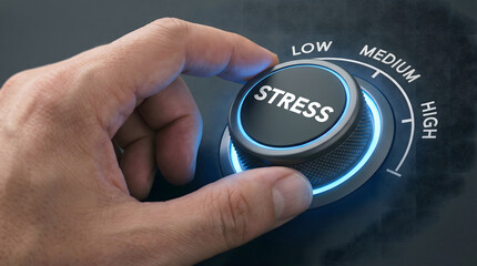 A human hand turning a digital stress control knob to adjust levels on a glowing dark pane