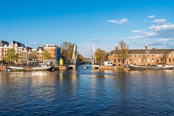 Obraz premium Experience Amsterdam s charm with this beautiful canal view showcasing historic architecture and houseboats. A perfect image to highlight the city s unique culture and tranquility.