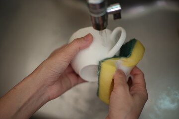 Wash the coffee cups, hand with coffee cup, Hands washing coffee cups.