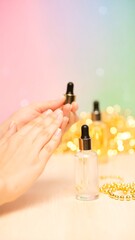 A soft-focus shot features a person's hands holding skincare products, with a pastel gradient backdrop & festive gold bokeh