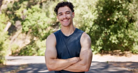 Fototapeta premium Portrait, fitness and happy man in street, arms crossed and confidence with nature. Outdoor, runner and person with pride, wellness and commitment to training routine, health benefits and exercise