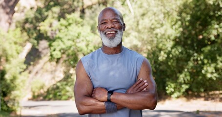 Fototapeta premium Portrait, fitness and black man with arms crossed, outdoor and funny with nature. Laughing, runner and mature person with humor wellness and commitment to workout routine, health benefits or exercise