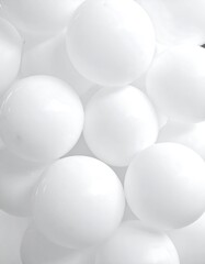 Close-up of glossy, pure-white spheres arranged in a textured, overlapping pattern