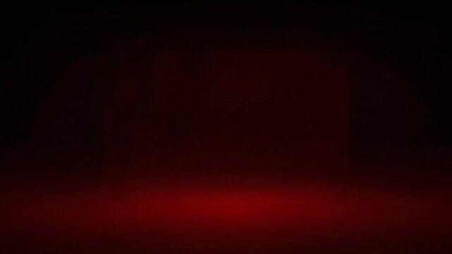 A textured, glowing red square framed in black, with hints of a dark surface within