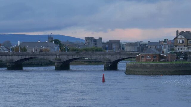 The Sarsfield Bridge over the River Shannon in Limerick, Ireland. Shot on a cloudy autumn during dusk.