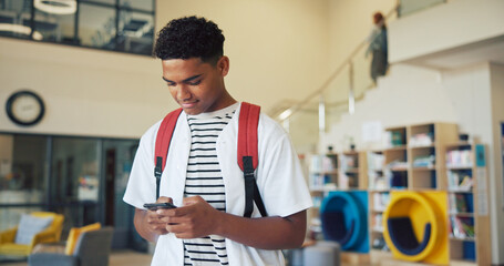 Plakat Education, phone and typing with boy student on high school campus for communication or study. App, learning and text message with teen learner in corridor for classroom schedule or timetable
