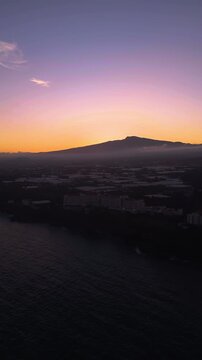 Vertical drone shot of the southern coastline of Jeju island, dusk in South Korea
