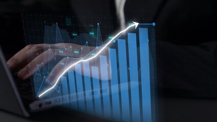 A businessman interacts with graphs and charts on his laptop, showcasing data-driven insights in a...