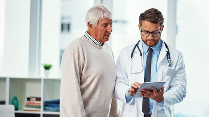 Doctor, old man and advice in office with tablet, consultation or check test results for patient help. Senior person, medical worker and discussion in clinic with tech, diagnosis or health insurance.