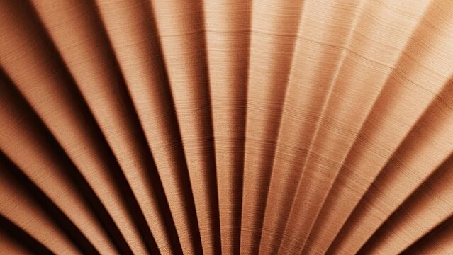 Close-up of tightly rolled paper scrolls showcasing texture and warm tones in abstract design