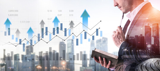 A businessman in a suit studies stock market trends while holding a book. The background features...
