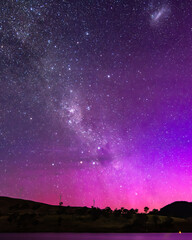 A Pink Aurora Australis and the Milky Way Shimmers Over the Dam